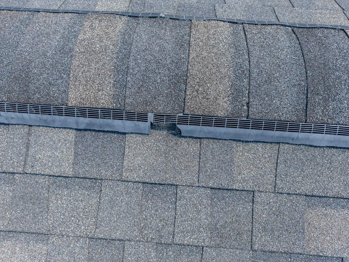 Close aerial view of ridge ventilation and adjoining shingle edges